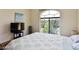 Cozy bedroom featuring a large window, a TV, and simple decor at 1605 Crimson Hills Dr # 204, Las Vegas, NV 89128