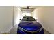 The image shows a one car garage with a blue car parked inside at 1605 Crimson Hills Dr # 204, Las Vegas, NV 89128