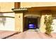 A garage, highlighted by a shiny blue vehicle and a brick driveway, providing secure parking at 1605 Crimson Hills Dr # 204, Las Vegas, NV 89128