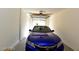 Well-lit garage with a shiny blue car parked inside, providing secure vehicle storage at 1605 Crimson Hills Dr # 204, Las Vegas, NV 89128