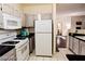 Functional kitchen with white appliances and dark countertops at 1605 Crimson Hills Dr # 204, Las Vegas, NV 89128