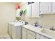 Laundry room with a washer, dryer, and storage cabinets at 1605 Crimson Hills Dr # 204, Las Vegas, NV 89128
