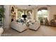The living room has a stone fireplace and large windows with seating for entertaining at 1605 Crimson Hills Dr # 204, Las Vegas, NV 89128