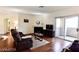 Inviting living room with fireplace, wood floors, and sliding glass door at 1605 Crimson Hills Dr # 204, Las Vegas, NV 89128