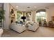Spacious living room featuring a fireplace, large windows, and elegant furnishings for a comfortable setting at 1605 Crimson Hills Dr # 204, Las Vegas, NV 89128