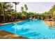 Large community pool surrounded by lush landscaping and lounge chairs at 1605 Crimson Hills Dr # 204, Las Vegas, NV 89128