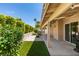 A covered patio overlooks artificial turf and privacy landscaping at 1824 Dawn Ridge Ave, Henderson, NV 89074
