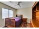 This bedroom offers wood floors, a ceiling fan, and a closet for storage at 1824 Dawn Ridge Ave, Henderson, NV 89074