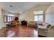 Cozy living room features hardwood floors, vaulted ceilings, with piano and natural light at 1824 Dawn Ridge Ave, Henderson, NV 89074