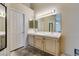 This bathroom has a large mirror and double sinks, but requires updating at 1824 Dawn Ridge Ave, Henderson, NV 89074