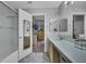 Bright bathroom features a dual sink vanity, large mirror, and enclosed shower at 2052 Gravel Hill St # 207, Las Vegas, NV 89117
