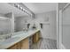 Bathroom features a dual sink vanity with a large mirror and shower at 2052 Gravel Hill St # 207, Las Vegas, NV 89117