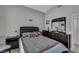 Comfortable bedroom featuring a dark wood dresser, bedside table, and queen-sized bed at 2052 Gravel Hill St # 207, Las Vegas, NV 89117