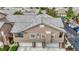 A lovely condo building with three garage doors, balcony, and stairs to upper unit at 2052 Gravel Hill St # 207, Las Vegas, NV 89117