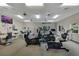 Well-equipped gym featuring modern exercise equipment, wall mirror, TV, and carpeted floor at 2052 Gravel Hill St # 207, Las Vegas, NV 89117