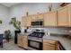 Well-lit kitchen features stainless steel appliances, wooden cabinets, and granite countertops at 2052 Gravel Hill St # 207, Las Vegas, NV 89117