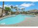 Community pool with surrounding palm trees at 2052 Gravel Hill St # 207, Las Vegas, NV 89117