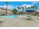 A large community pool with lounge chairs, palm trees, and well-maintained landscaping at 2052 Gravel Hill St # 207, Las Vegas, NV 89117