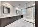 Modern bathroom with dual vanities, granite countertops, and a spacious walk-in shower with granite walls at 2215 Bannerwood St, Henderson, NV 89044