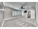 Spacious bedroom with soft carpeting, natural light from shuttered windows, and access to the backyard at 2215 Bannerwood St, Henderson, NV 89044