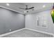 Neutral bedroom featuring carpet flooring, a ceiling fan, white baseboards, and a mounted tv at 2215 Bannerwood St, Henderson, NV 89044