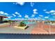 A refreshing community pool with plenty of lounge chairs and umbrellas under a bright sky at 2215 Bannerwood St, Henderson, NV 89044