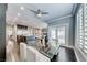 Bright dining area featuring glass table with seating, hardwood floors, and view of kitchen and living area at 2215 Bannerwood St, Henderson, NV 89044