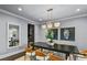 Bright dining room showcases a modern chandelier, neutral colors, and views to the main living room at 2215 Bannerwood St, Henderson, NV 89044