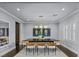 Formal dining room with modern lighting fixture, neutral color palette, large dining table with chairs at 2215 Bannerwood St, Henderson, NV 89044