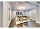 A dining room featuring hardwood floors, area rug, and modern light fixture over dark wood table with seating for eight at 2215 Bannerwood St, Henderson, NV 89044