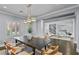 Formal dining room styled with modern chandelier, neutral palette, and views into a comfortable living space at 2215 Bannerwood St, Henderson, NV 89044