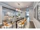 Elegant dining room with hardwood floors, contemporary chandelier, neutral decor, and inviting ambiance at 2215 Bannerwood St, Henderson, NV 89044