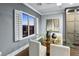 Elegant dining room featuring a glass table, shutters, and built-in cabinet storage at 2215 Bannerwood St, Henderson, NV 89044