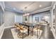 Bright dining room with dark hardwood floors, shutters on windows, and adjacent living area at 2215 Bannerwood St, Henderson, NV 89044