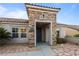 Exterior front entrance featuring a stone column and desert landscaping at 2215 Bannerwood St, Henderson, NV 89044