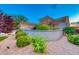 Well-maintained home boasting desert landscaping, a charming stone wall, and vibrant green bushes at 2215 Bannerwood St, Henderson, NV 89044