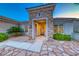 Attractive home featuring a stone accent entry, a decorative front door, and beautiful desert landscaping at 2215 Bannerwood St, Henderson, NV 89044