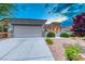 Charming home featuring a two-car garage, low maintenance desert landscaping and a stone facade at 2215 Bannerwood St, Henderson, NV 89044