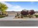 Well-maintained single-story home featuring a landscaped yard and attached two-car garage at 2215 Bannerwood St, Henderson, NV 89044