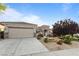 Charming single-story home featuring a well-manicured yard and a two-car garage on a sunny day at 2215 Bannerwood St, Henderson, NV 89044