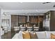 Well-equipped kitchen with dark wood cabinets, stainless steel appliances, and bar seating at 2215 Bannerwood St, Henderson, NV 89044