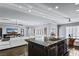 Open concept view of the kitchen, dining area, and living room with natural light at 2215 Bannerwood St, Henderson, NV 89044