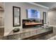 Stylish living room with a modern fireplace, sleek entertainment center, and hardwood flooring at 2215 Bannerwood St, Henderson, NV 89044