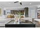 Bright, open-concept living room with white sectional sofa and view of the modern kitchen at 2215 Bannerwood St, Henderson, NV 89044