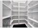 Empty white walk-in closet with custom shelving providing lots of storage at 2215 Bannerwood St, Henderson, NV 89044