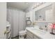 Bright bathroom featuring a vanity with modern fixtures and a shower with patterned curtain, designed for comfort at 2240 Highpointe Dr # 203, Laughlin, NV 89029