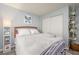 Cozy bedroom with soft lighting, a plush bed, and a white storage closet featuring additional shelves at 2240 Highpointe Dr # 203, Laughlin, NV 89029