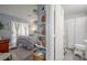 Bedroom with hanging plants on shelves, balcony access, and an attached bathroom with a toilet and shower at 2240 Highpointe Dr # 203, Laughlin, NV 89029