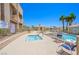 Community pool and jacuzzi with seating and desert landscaping at 2240 Highpointe Dr # 203, Laughlin, NV 89029