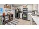 Functional kitchen with white cabinets, black appliances, and contrasting rug offering a blend of style and convenience at 2240 Highpointe Dr # 203, Laughlin, NV 89029